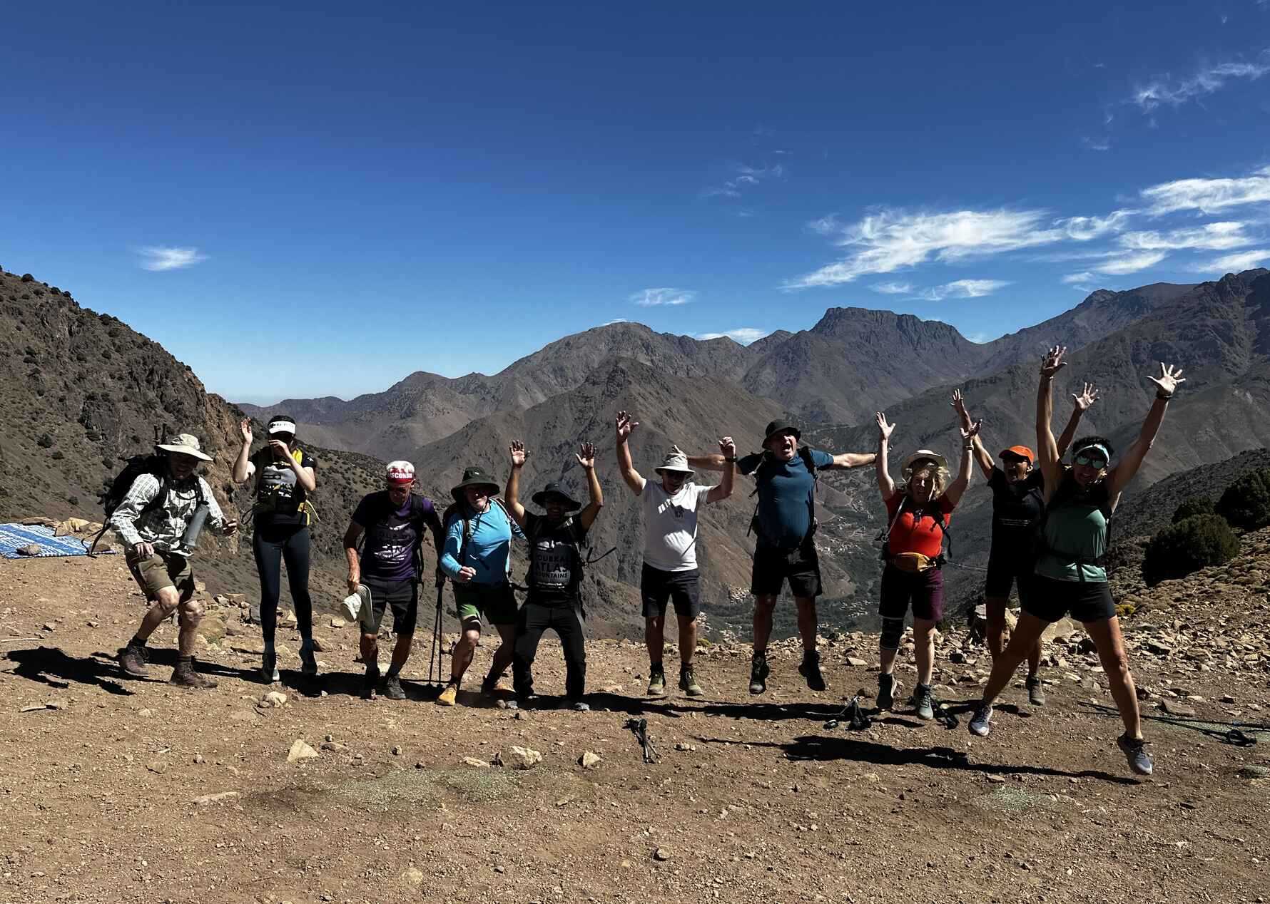 A group of hikers jumping in the air