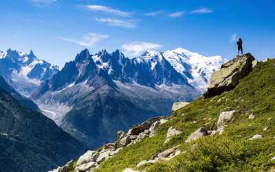 A trekker looking at a stunning view of Mont Blanc